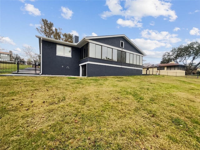 back of house featuring a yard