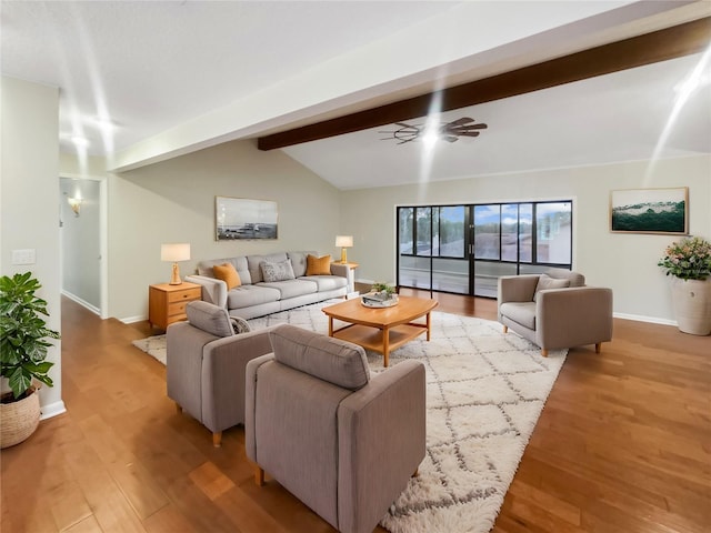 living room featuring light hardwood / wood-style floors, ceiling fan, and lofted ceiling with beams