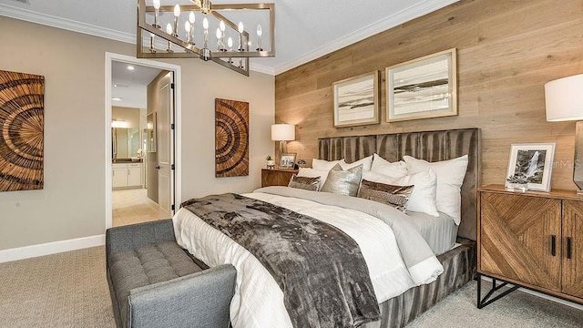 bedroom featuring ensuite bathroom, ornamental molding, light colored carpet, a chandelier, and wood walls