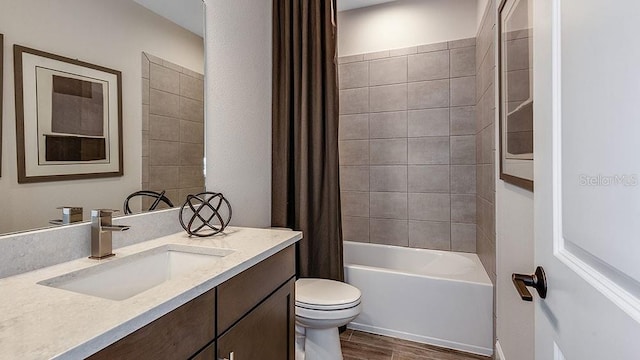 full bathroom featuring vanity, shower / tub combo, and toilet