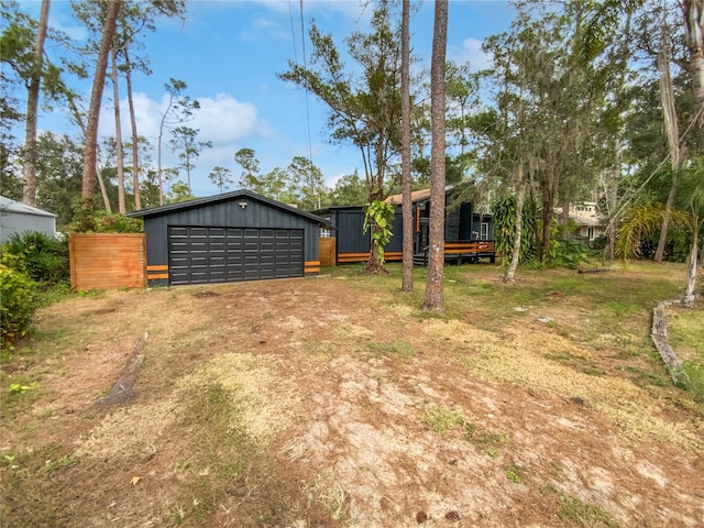 view of yard featuring a garage and an outdoor structure