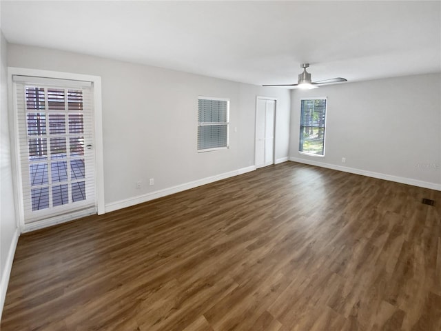 empty room featuring ceiling fan and dark wood-type flooring