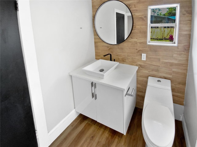 bathroom featuring hardwood / wood-style flooring, vanity, and toilet