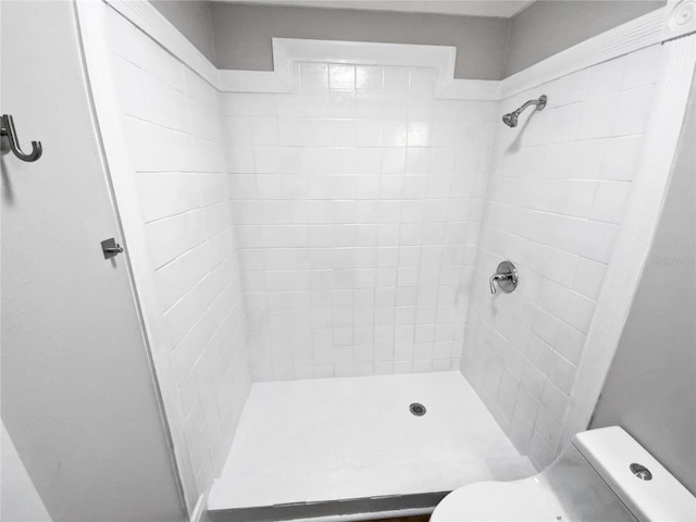 bathroom featuring toilet and tiled shower