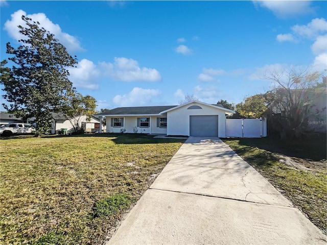 single story home featuring a garage and a front lawn