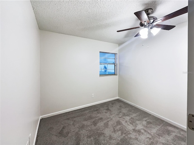 carpeted spare room featuring a textured ceiling and ceiling fan