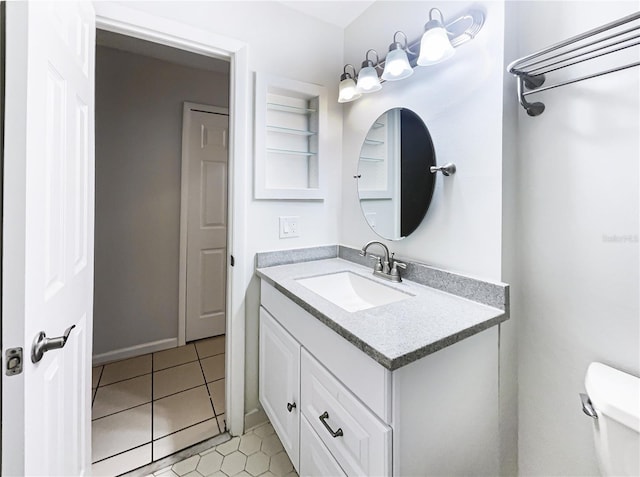 bathroom featuring toilet, tile patterned floors, and vanity