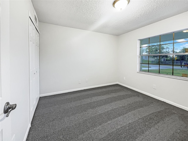 unfurnished bedroom featuring a textured ceiling and a closet