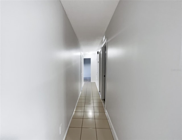 hall featuring light tile patterned floors