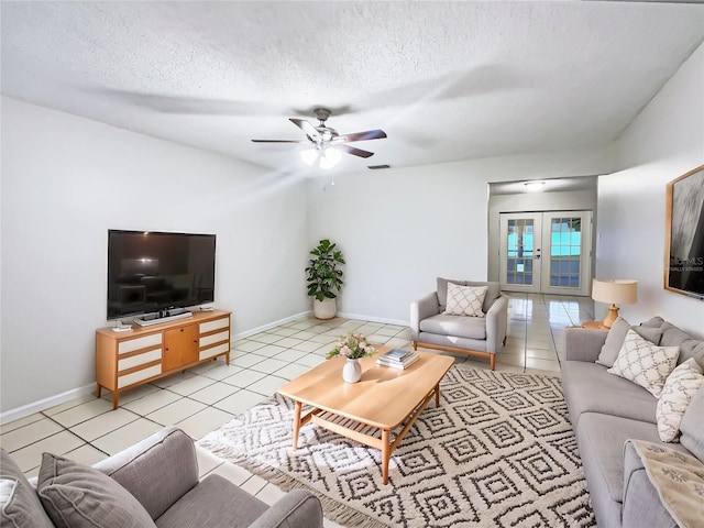 tiled living room featuring ceiling fan, french doors, and a textured ceiling