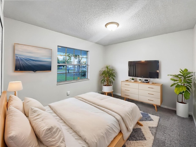 carpeted bedroom featuring a textured ceiling