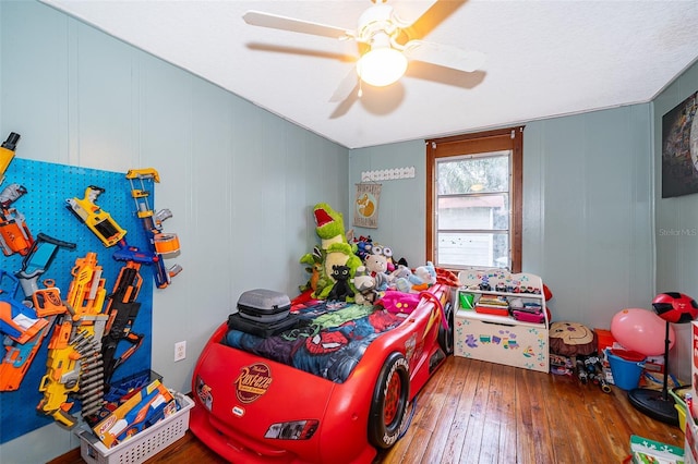 bedroom featuring ceiling fan and hardwood / wood-style flooring