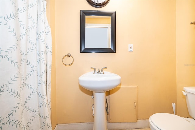 bathroom featuring toilet and walk in shower