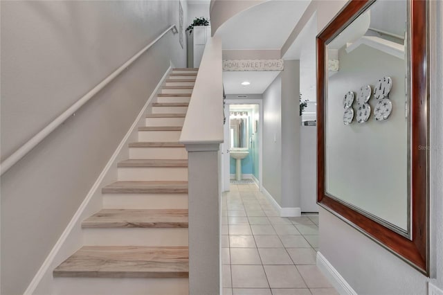 stairway featuring tile patterned flooring