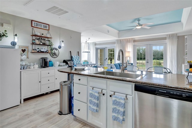 kitchen with white cabinetry, dishwasher, french doors, and sink