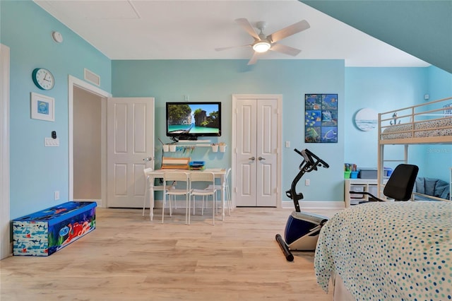 bedroom featuring ceiling fan, light wood-type flooring, and a closet