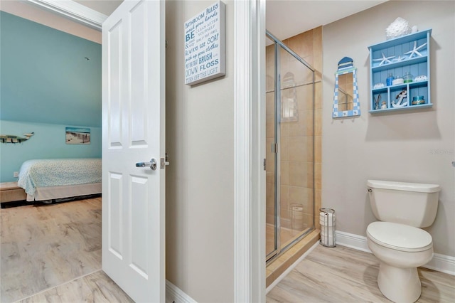 bathroom featuring an enclosed shower, toilet, and hardwood / wood-style flooring