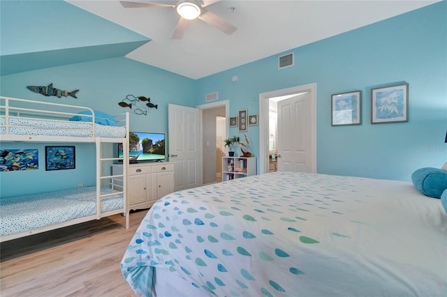 bedroom featuring light wood-type flooring, ceiling fan, and lofted ceiling