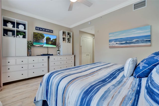 bedroom with light wood-type flooring, ceiling fan, crown molding, and a closet