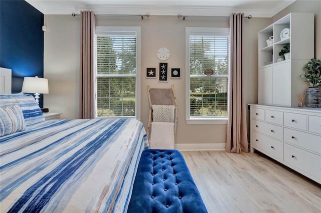 bedroom featuring light hardwood / wood-style flooring and crown molding