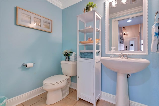 bathroom with toilet, tile patterned flooring, and ornamental molding