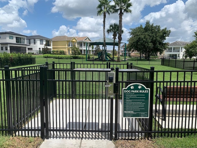 view of gate with a yard