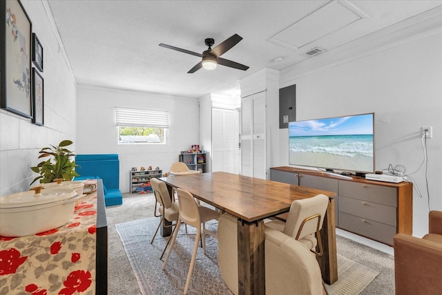 dining room with ceiling fan, light colored carpet, and crown molding