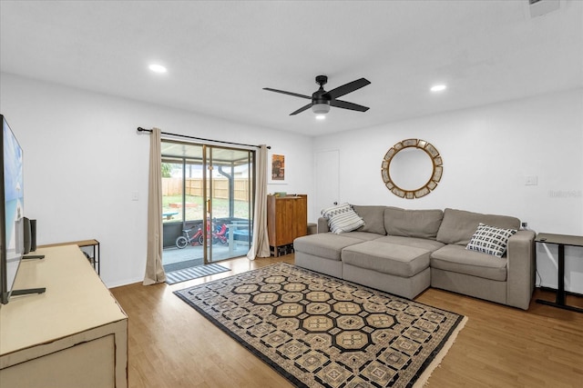 living room featuring light hardwood / wood-style floors and ceiling fan