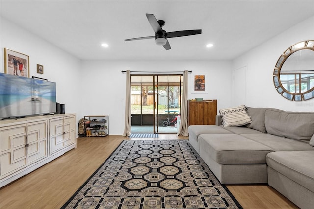 living room with light hardwood / wood-style floors and ceiling fan