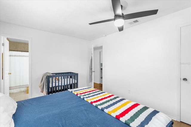 bedroom featuring ceiling fan and connected bathroom