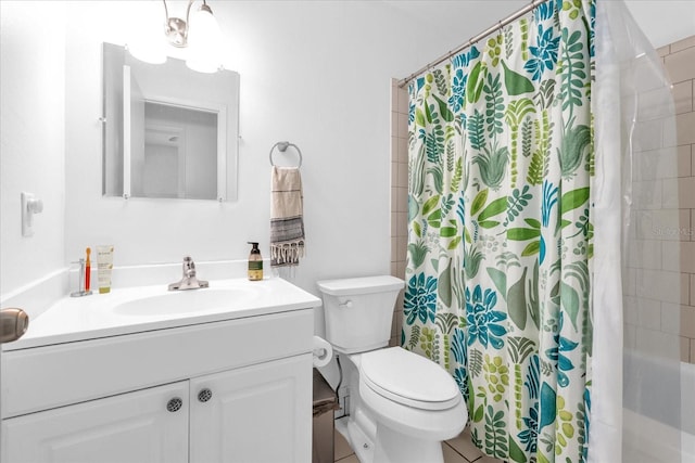 bathroom with tile patterned flooring, vanity, and toilet