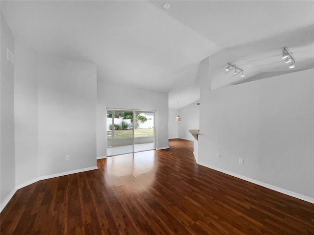 unfurnished living room with lofted ceiling, track lighting, and dark hardwood / wood-style flooring