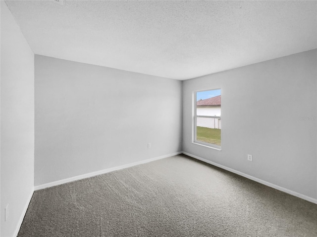 carpeted spare room featuring a textured ceiling