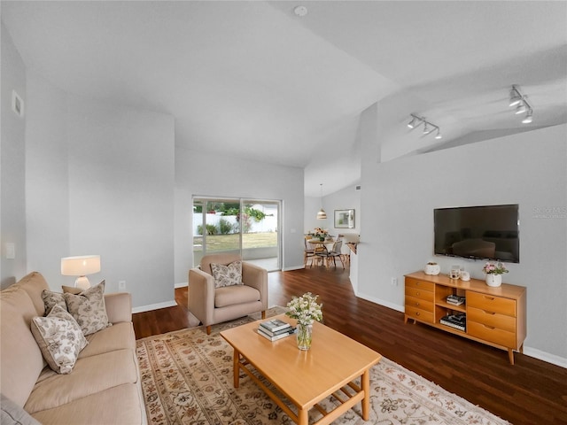 living room featuring dark wood-type flooring, vaulted ceiling, and rail lighting