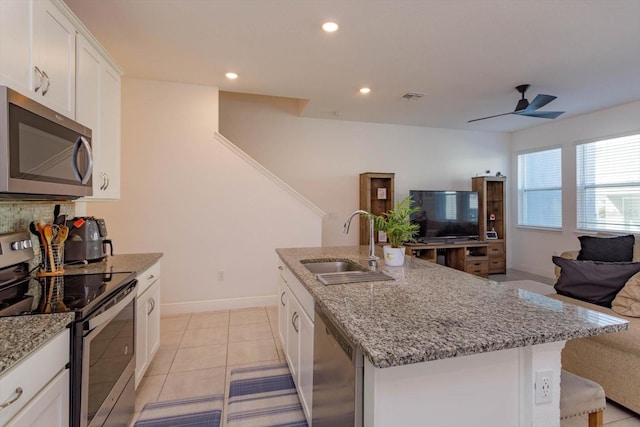 kitchen with sink, a center island with sink, white cabinetry, and appliances with stainless steel finishes