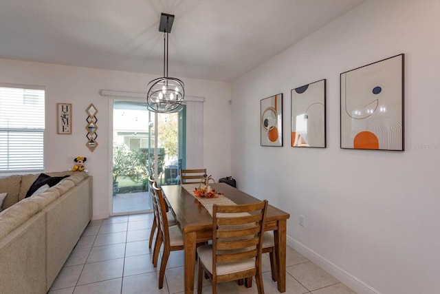 dining room featuring a notable chandelier and light tile patterned floors