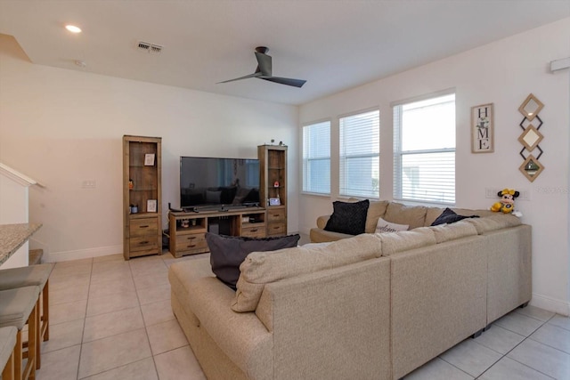 tiled living room with ceiling fan