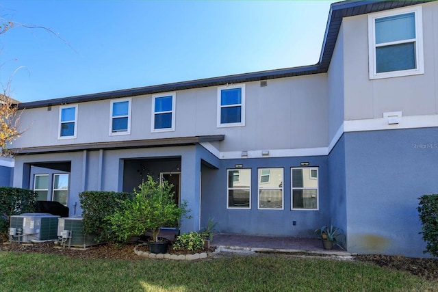 rear view of house with a patio and central AC