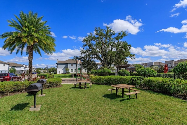 view of home's community with a yard and a playground