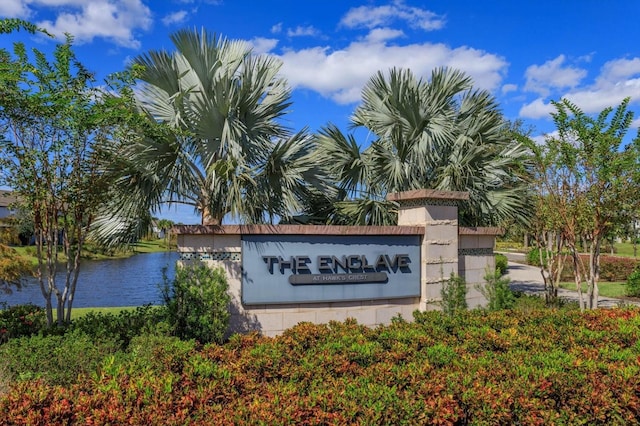 community / neighborhood sign featuring a water view