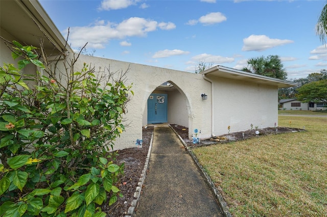 doorway to property featuring a yard