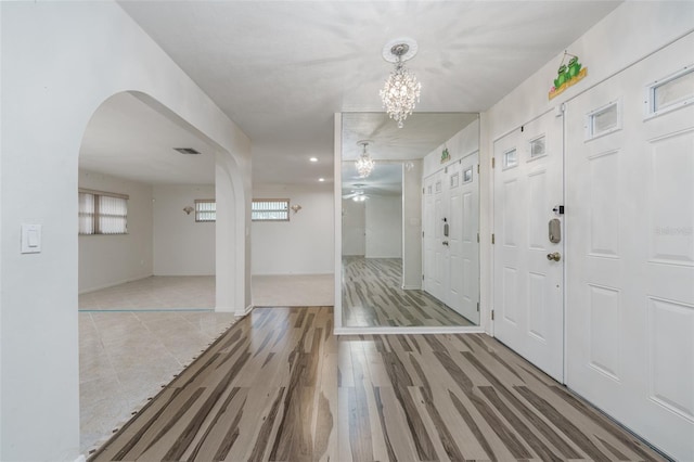 entrance foyer with a notable chandelier and hardwood / wood-style floors