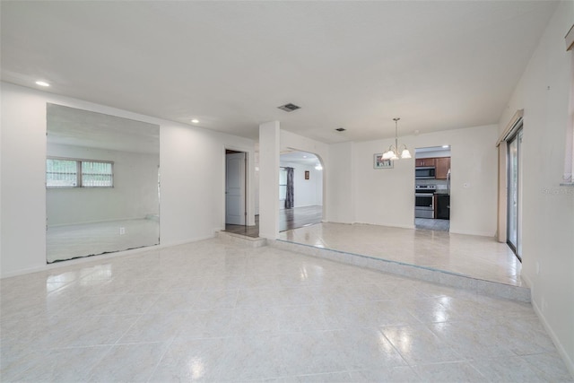 empty room featuring a chandelier