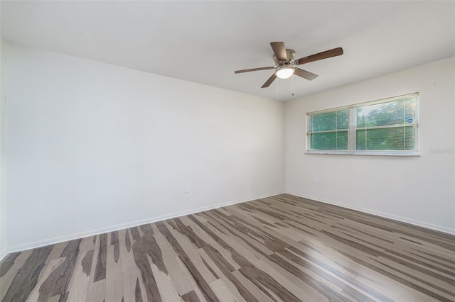 empty room featuring hardwood / wood-style flooring and ceiling fan