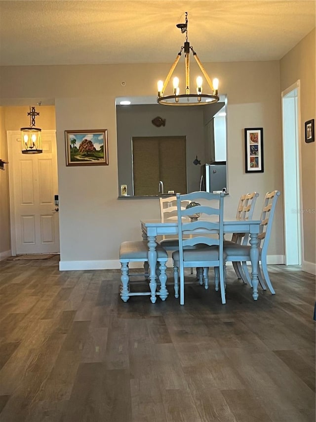 dining space featuring dark hardwood / wood-style floors and a notable chandelier