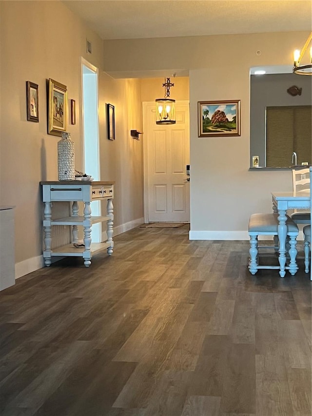 entryway featuring dark hardwood / wood-style flooring and a notable chandelier