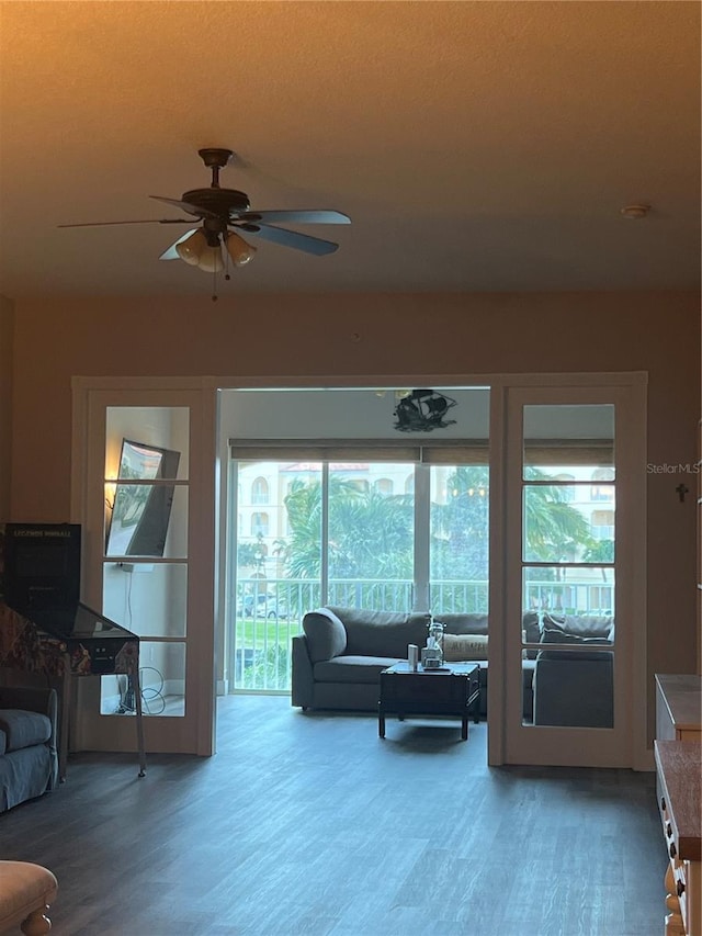 living room featuring ceiling fan and hardwood / wood-style flooring