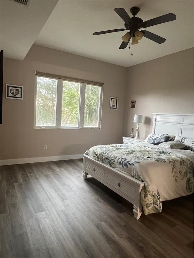 bedroom featuring ceiling fan and dark hardwood / wood-style flooring