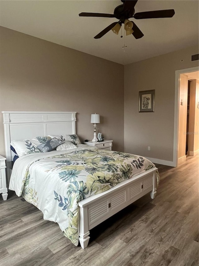 bedroom with ceiling fan and wood-type flooring