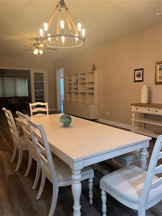 dining room featuring ceiling fan with notable chandelier and hardwood / wood-style flooring